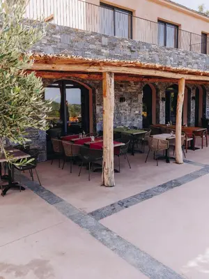 a wooden pavilion with tables and chairs on a patio at Domaine Santa Margherita in Castellare-di-Casinca
