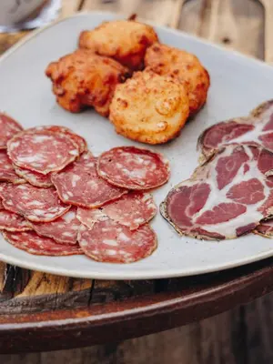 a plate of salami and other meats on a table at Domaine Santa Margherita in Castellare-di-Casinca