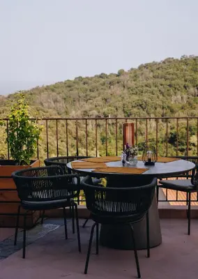 a table and chairs on a balcony with a view at Domaine Santa Margherita in Castellare-di-Casinca