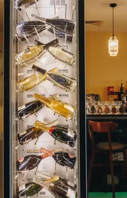 a display case filled with bottles of wine at Domaine Santa Margherita in Castellare-di-Casinca