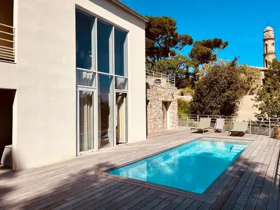 a house with a swimming pool on a wooden deck at La Villa di Paraso in Ville-di-Paraso