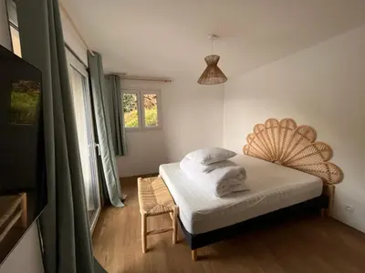 a bedroom with a bed and a chair in it at La Villa di Paraso in Ville-di-Paraso