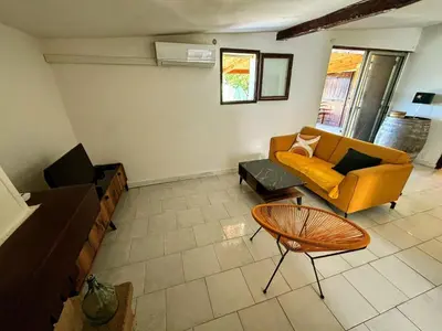 a living room with a couch and a table at A casetta di l alivu in Lucciana
