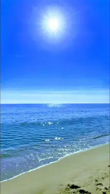 a view of the ocean with the sun in the sky at A casetta di l alivu in Lucciana