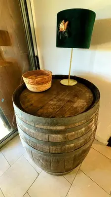 a wooden barrel table with a lamp on top of it at A casetta di l alivu in Lucciana