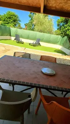 a table and chairs on a patio at A casetta di l alivu in Lucciana