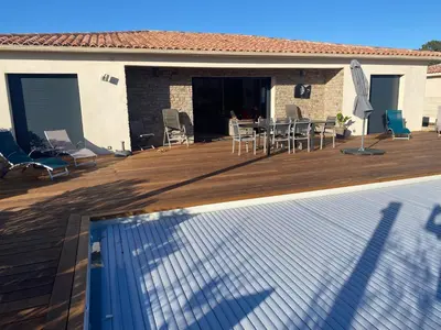 a swimming pool in front of a house at Villa standing Arciquadra Porto Vecchio in Lecci