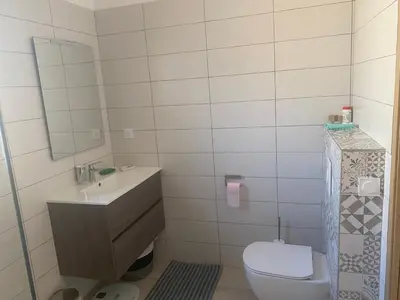a bathroom with a toilet and a sink and a mirror at Villa standing Arciquadra Porto Vecchio in Lecci