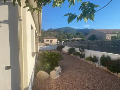 a courtyard with plants and a fence with a view at Villa standing Arciquadra Porto Vecchio in Lecci