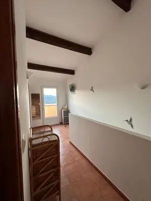 a hallway of a house with a room with a window at Appartement MAEVA duplex vue mer à Favone in Conca