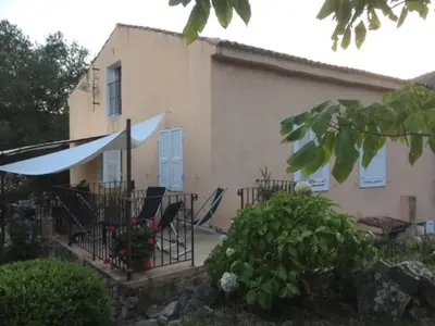 a house with a patio with chairs and a table at BandB les rosiers - chambre Eglantine in Conca