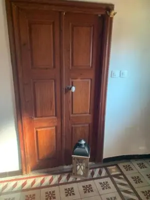 a wooden door with a candle in front of it at BandB les rosiers - chambre Eglantine in Conca