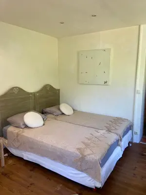 a bedroom with a bed with two pillows on it at BandB les rosiers - chambre Eglantine in Conca