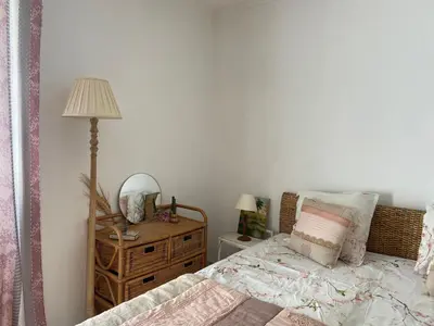 a bedroom with a bed and a table with a lamp at BandB les rosiers - chambre Garance in Conca