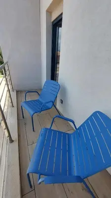 two blue chairs and a bench on a balcony at Casa di Lume - Superbe T3 4 étoiles à Bonifacio in Bonifacio