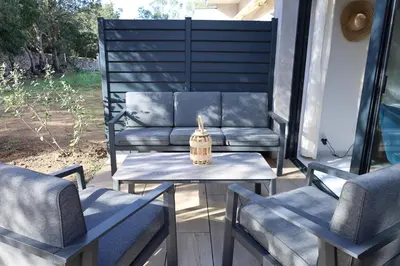 two chairs and a table with a candle on a porch at Casa di Lume - Superbe T3 4 étoiles à Bonifacio in Bonifacio