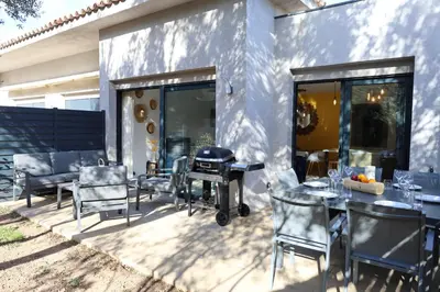 a patio with tables and chairs and a grill at Casa di Lume - Superbe T3 4 étoiles à Bonifacio in Bonifacio