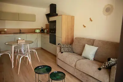a living room with a couch and a table at Le Berceau d'Asciaghju Palombaggia - Accès plage et Piscine privée in Porto-Vecchio