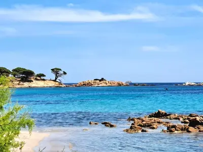 a group of rocks in the water on a beach at Le Berceau d'Asciaghju Palombaggia - Accès plage et Piscine privée in Porto-Vecchio