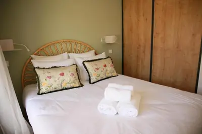 a bed with two folded towels on top of it at Le Berceau d'Asciaghju Palombaggia - Accès plage et Piscine privée in Porto-Vecchio