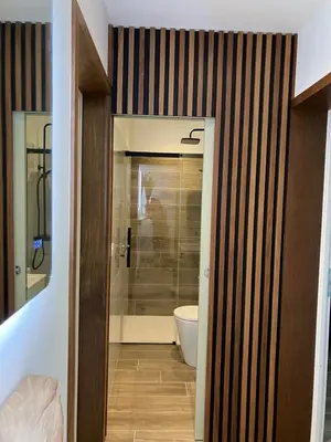 a bathroom with a toilet and a glass door at Villa vue mer, jardin terrasse, parking privé à 300m du centre-ville de Porto-Vecchio in Porto-Vecchio