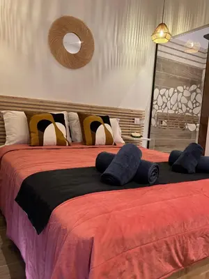 two beds with pillows on them in a bedroom at Villa vue mer, jardin terrasse, parking privé à 300m du centre-ville de Porto-Vecchio in Porto-Vecchio