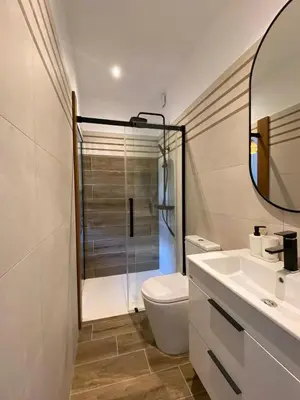a bathroom with a shower and a toilet and a sink at Villa vue mer, jardin terrasse, parking privé à 300m du centre-ville de Porto-Vecchio in Porto-Vecchio