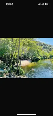 a picture of a river with a person swimming in it at Lodge A NASSA in Olivese