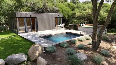 a small house with a swimming pool in a yard at chalet Arena in Porto-Vecchio
