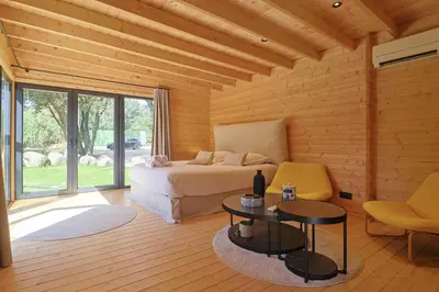 a bedroom with a bed and a table and chairs at chalet Arena in Porto-Vecchio