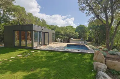 a tiny house with a pool in a yard at chalet Arena in Porto-Vecchio