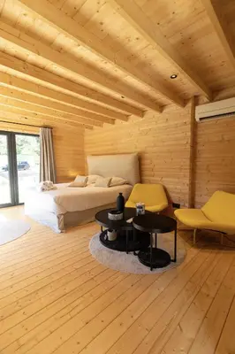 a bedroom with a bed and a table and chairs at chalet Arena in Porto-Vecchio