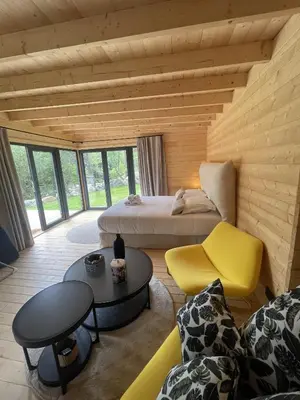 a room with a bed and a couch and a table at chalet Arena in Porto-Vecchio