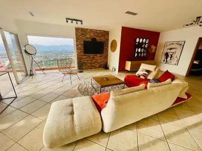 a living room with a couch and a fireplace at Villa Sì- Villa indépendante 3 chambres avec piscine et magnifique vue mer en plein centre de Porticcio in Porticcio