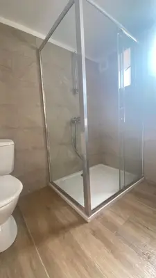 a glass shower in a bathroom with a toilet at A casa di Leia in Borgo