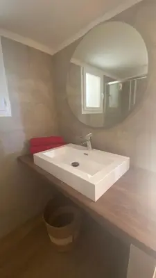 a bathroom with a white sink and a mirror at A casa di Leia in Borgo