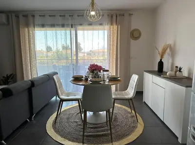 a dining room table and chairs in a kitchen at 5 min des plages - Appt 2 chambres A Casa Bella in Lucciana