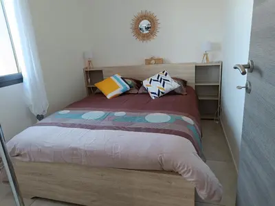 a bedroom with a large bed with pillows on it at Doume et Coco T1 30M2 Vue mer in Taglio-Isolaccio