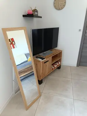 a mirror sitting on a stand next to a tv at Doume et Coco T1 30M2 Vue mer in Taglio-Isolaccio