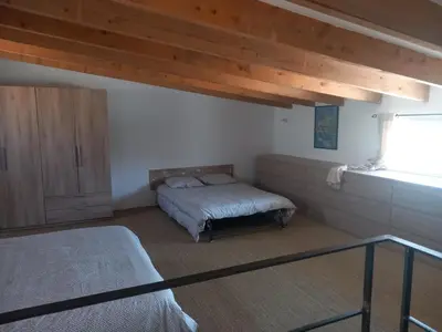 a bedroom with a bed and a cabinet and a window at maison de vacances olmi cappella Corse in Olmi-Cappella