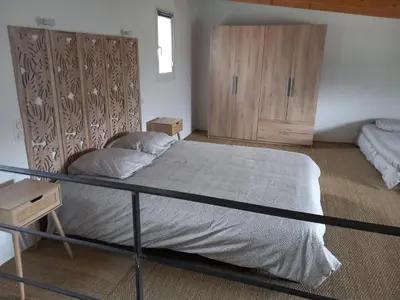 a bedroom with a large bed and wooden cabinets at maison de vacances olmi cappella Corse in Olmi-Cappella