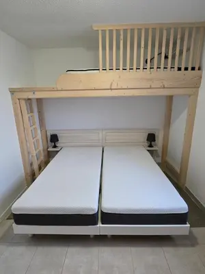 a bunk bed with two mattresses on top of it at Villa 7 personnes résidence Mélody in Santa-Maria-Poggio