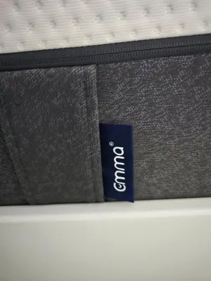 a mattress with a label on it on a bed at Villa 7 personnes résidence Mélody in Santa-Maria-Poggio