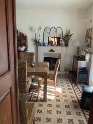 a dining room with a table and a fireplace at BandB les rosiers - Hellébore in Conca
