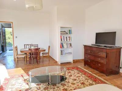a living room with a table and a tv on a dresser at Lemon in Casaglione