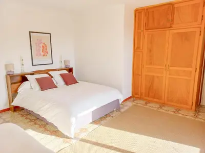a bedroom with a white bed and a wooden cabinet at Lemon in Casaglione