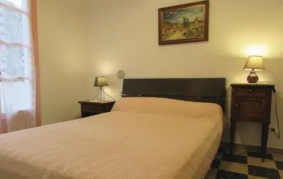 a bedroom with a bed and a picture on the wall at Holiday Home Sagone Xlvii in Sagone