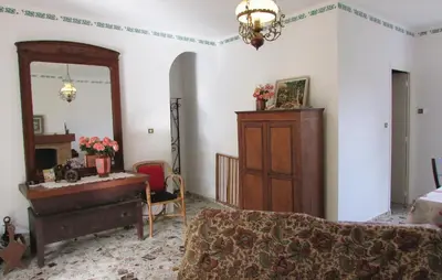 a bedroom with a bed and a desk and a mirror at Holiday Home Sagone Xlvii in Sagone