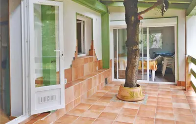 a house with a tree in the middle of a floor at Nice Apartment In Sagone With Kitchen in Sagone