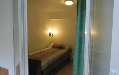 a small bedroom with a small bed in a room at Nice Apartment In Sagone With Kitchen in Sagone